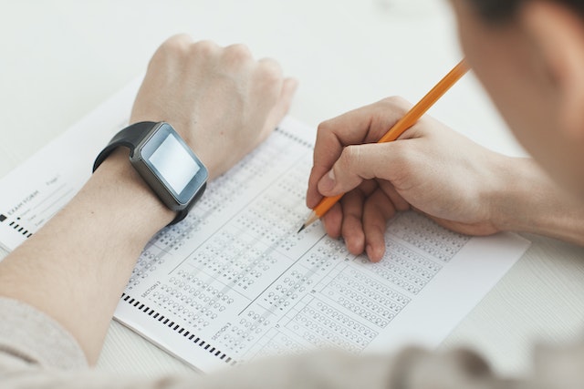 A teenager completing a test in the form of filling in circles, similar to an A.C.T. test