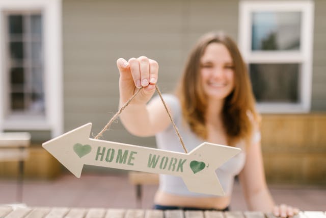 Complete Math Homework: lady holding up a homework sign