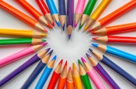 Pencils in Math and Beyond: How to Successfully Utilize:Vibrant colored pencils creatively arranged in a heart shape on a white background.